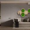 Hexagon wooden wall shelf and green moss art set mounted above a sofa in a brightly lit modern living room