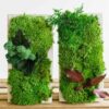 Set of two upright concrete planters filled with textured green moss and decorative leaves on wooden slats.