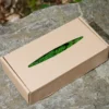 Kraft cardboard box with a cut-out window displaying preserved green ball moss on a rock