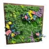 Preserved moss wall art with floral accents and foliage in a wooden frame