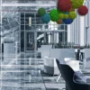 Colorful reindeer moss balls in red, green, and blue hanging from the ceiling of a modern building lobby lounge.