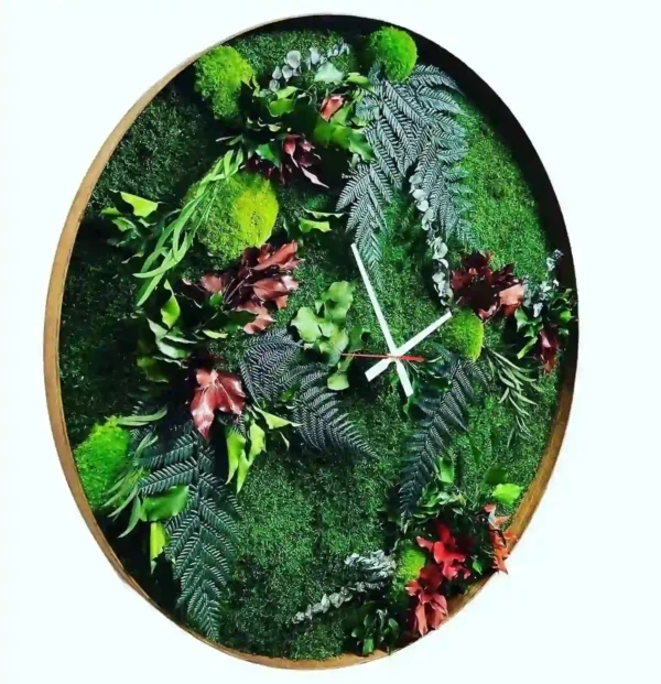 Round wall clock filled with preserved moss and botanical foliage, featuring minimalist clock hands