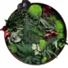 Round moss wall art with preserved ferns, foliage, and burgundy leaves in a dark brown wooden frame.