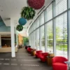 Hanging red and blue reindeer moss balls with foliage spheres suspended from a modern lobby ceiling