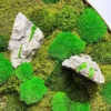 Green moss wall art with textured gray rocks and bright green moss mounds.