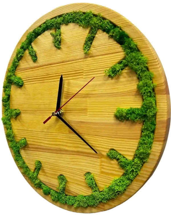 Round wooden wall clock with preserved green moss inlaid along the perimeter and hour marks.