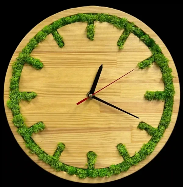 Round wooden wall clock with green moss inlaid around the rim to mark hours, with black and red hands.