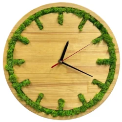 Round wooden wall clock with carved hour markers filled with green moss and black hands.