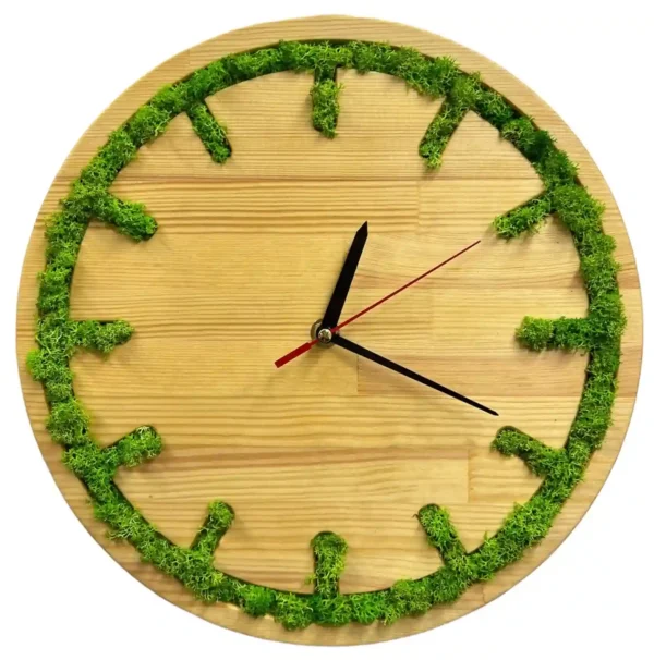 Round wooden wall clock with carved hour markers filled with green moss and black hands.
