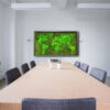 conferenc-map2.-5.jpg Rectangular moss world map wall art mounted on white wall over long conference table in bright modern office.