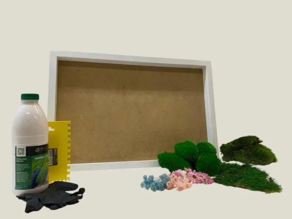 DIY moss picture kit with empty frame, adhesive bottle, applicator tool, work gloves, preserved moss, and dried flowers.