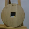 Back of round wood wall clock (23 cm) with recessed battery mechanism and sawtooth hanging bracket