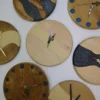 Collection of round wood and epoxy resin wall clocks featuring various river inlays and dot designs.