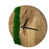 Round solid oak wall clock with green moss inlay and black hands in an angled view