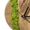 Close-up of round wooden wall clock featuring textured green lichen moss inlay and natural wood grain