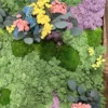 Detail of botanical moss panel with green ball moss, purple reindeer moss, and multicolored dried flowers