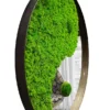 Round yin-yang mirror with green reindeer and ball moss in a dark wooden frame, viewed from the side.