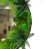 Round moss mirror detail with lush green ball moss, ferns, and trailing foliage inside a white frame.