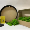 DIY moss art kit with round black frame, preserved green reindeer moss, glue bottle, spatula, and gloves