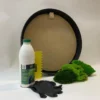 Round black wooden frame DIY moss kit with craft glue bottle, yellow spreader, black gloves, and green preserved moss.