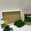 DIY moss wall art kit with white frame, boxed green ball moss, glue bottle, notched spreader, and protective glove.