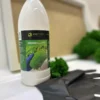Bottle of Ekomoss moss glue with a green cap, black protective glove, and green moss on a crafting surface.