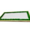 Rectangular mirror with natural wood frame and green ball moss inner border, angled view
