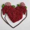 Red preserved moss heart wall art with pink and green accents in a dark brown wooden embrace outline frame.
