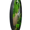 Side view of round black frame mirror displaying textured green preserved moss and plants
