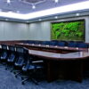 meeting-room-map4.-2.jpg Rectangular moss world map wall art mounted on a conference room wall above a large boardroom table