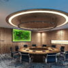 meeting-room-map6.-2.jpg Illuminated green moss world map wall art on a wood-paneled wall in a modern circular conference room.