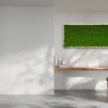 Rectangular green moss wall art mounted above a wooden desk in a minimalist workspace.