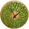 Round wooden wall clock featuring patterned cutouts filled with preserved moss and minimalist black hands