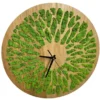 Round natural wood wall clock featuring vibrant green reindeer moss in decorative cutouts with black hands
