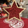 Natural wood star frame filled with red reindeer moss (10.6") on a red-and-white table runner.