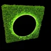 Square green moss wall panel with a round backlit mirror cutout on a black background.