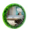Round moss mirror with perimeter lighting reflecting a modern bedroom