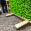 Caster wheels and wooden base of a mobile green moss room divider screen