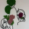Black line art female face wall silhouettes accented with green, pink, and purple preserved reindeer moss