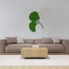 Green moss woman portrait wall decor mounted above a sofa in a modern living room