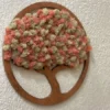 Round wooden tree wall art with pink and cream preserved moss canopy on a white textured wall
