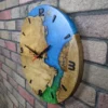 Side view of round wood wall clock with blue and green epoxy resin on a brick wall
