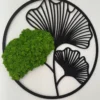 Round black frame featuring ginkgo leaf silhouette cutout filled with textured green preserved moss