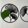 Circular black ginkgo leaf wall art featuring textured green preserved moss on a white wall
