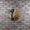 Oak and black epoxy resin wall clock with white hands mounted on a multi-toned brick wall