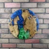 Round oak wall clock with swirling blue and green epoxy resin mounted on a brick wall