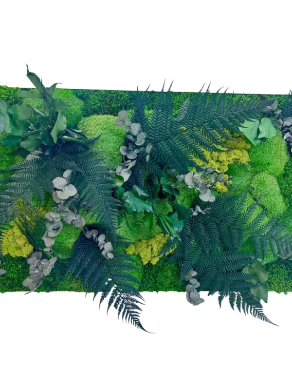 Close-up of jungle plant wall art featuring preserved fern fronds, eucalyptus leaves, and textured moss.