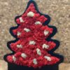 Christmas tree shaped black wooden frame filled with red and white reindeer moss