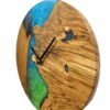 Side angle of round solid oak wall clock featuring vibrant blue and green epoxy resin and black hands