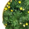 Close-up of round moss wall art with green Rose of Jericho fronds, small yellow flowers, and a natural wood frame